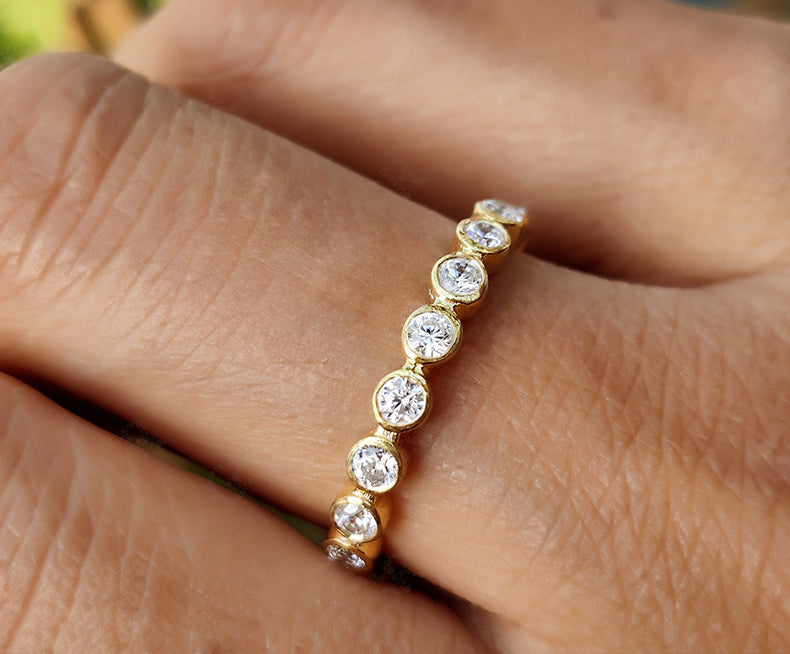 Radiate Elegance with a 2.20 mm Round Bezel Moissanite Women's Wedding Band – Available in Silver and Gold. Elevate Your Style with a Full Eternity Brilliant Cut Moissanite Ring, Ideal for Stacking