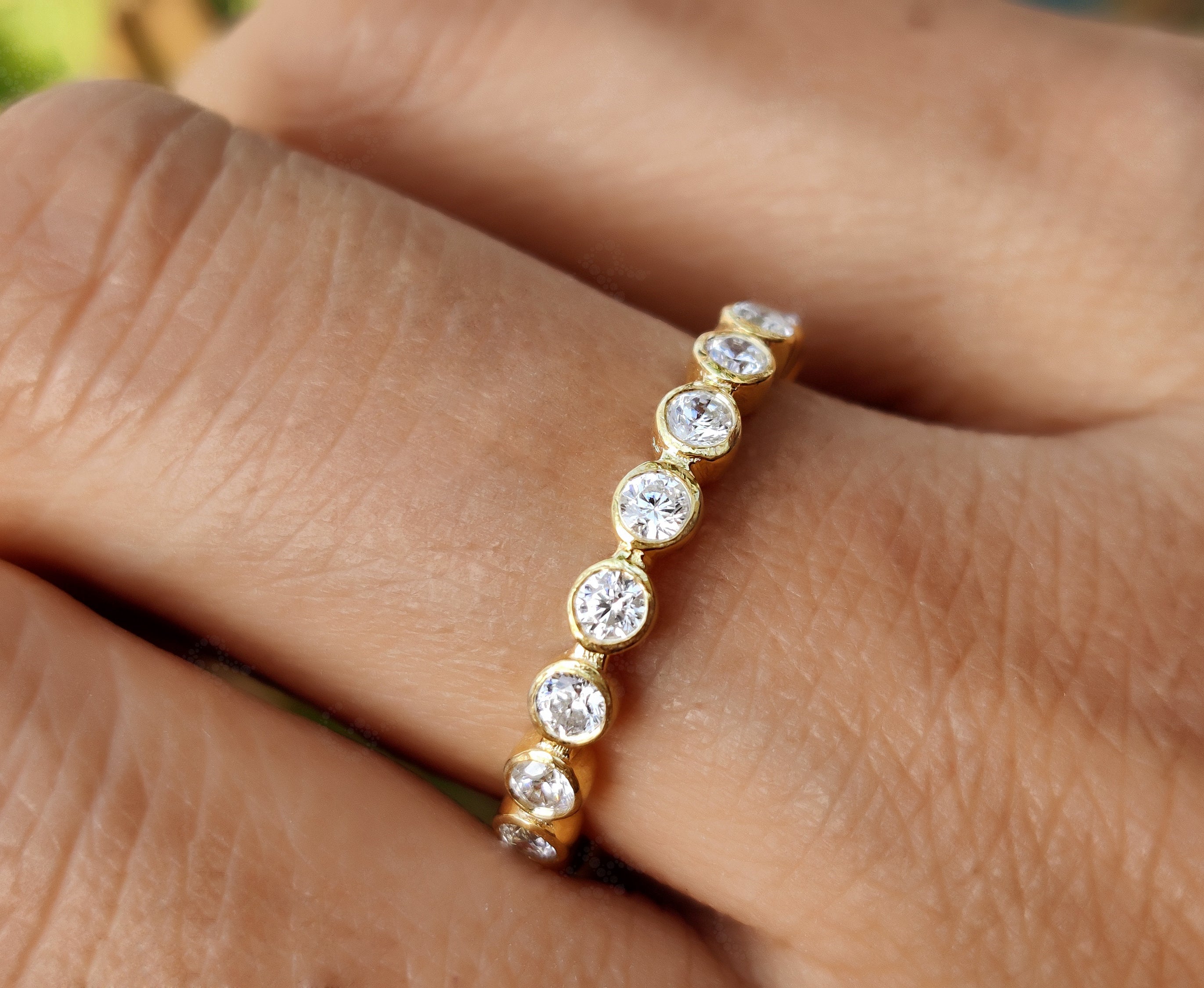 Radiate Elegance with a 2.20 mm Round Bezel Moissanite Women's Wedding Band – Available in Silver and Gold. Elevate Your Style with a Full Eternity Brilliant Cut Moissanite Ring, Ideal for Stacking