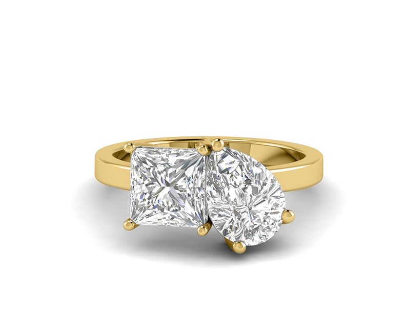 Pear and princess cut Toi Et Moi gold ring with a romantic two stone design. A unique and elegant ring perfect for proposals, anniversaries, or gifts.