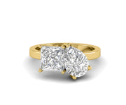 Pear and princess cut Toi Et Moi gold ring with a romantic two stone design. A unique and elegant ring perfect for proposals, anniversaries, or gifts.