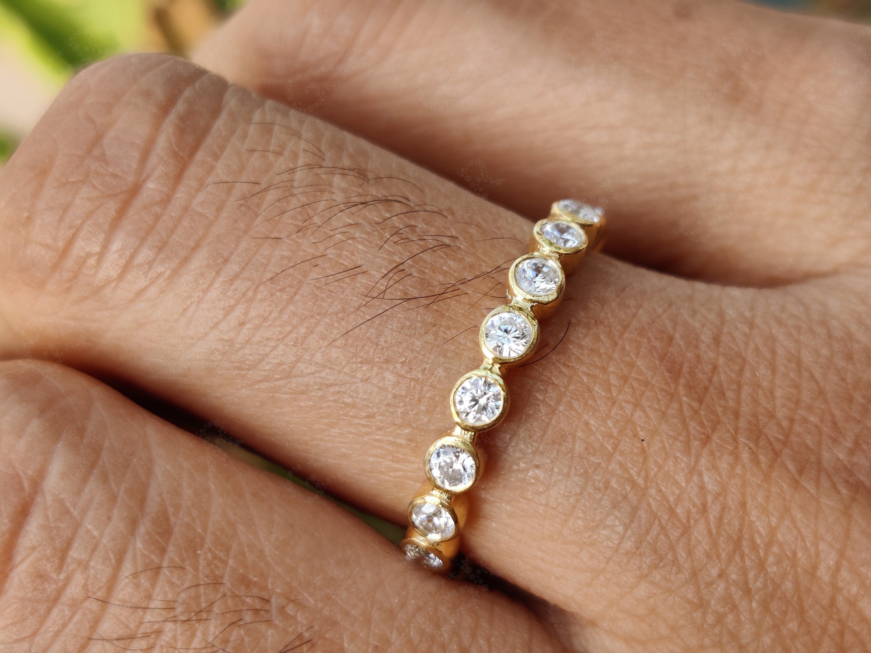 Radiate Elegance with a 2.20 mm Round Bezel Moissanite Women's Wedding Band – Available in Silver and Gold. Elevate Your Style with a Full Eternity Brilliant Cut Moissanite Ring, Ideal for Stacking